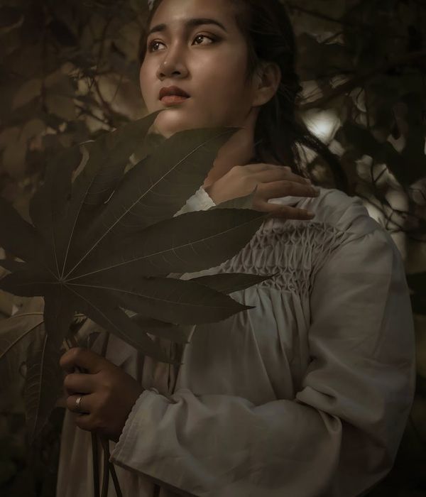 Person meditating in a serene natural setting, looking peaceful.